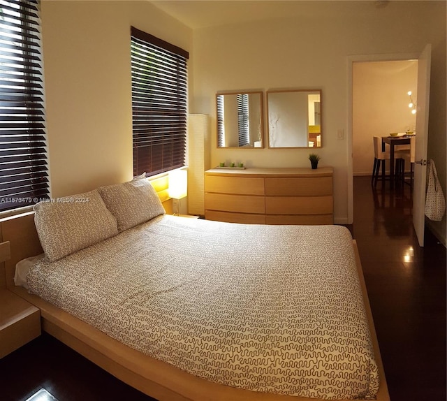 bedroom featuring dark wood-type flooring and multiple windows