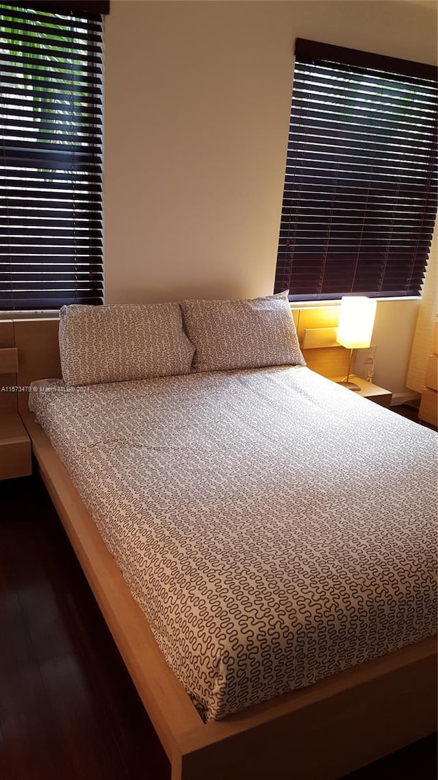 bedroom featuring dark hardwood / wood-style flooring