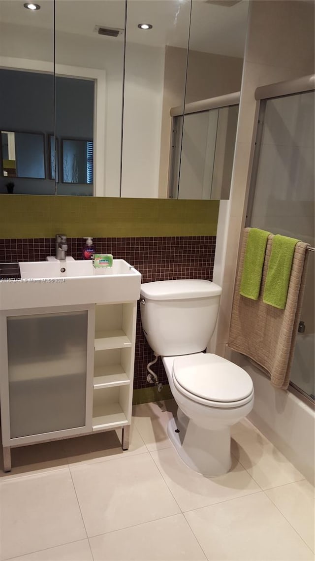 bathroom with tasteful backsplash, toilet, and tile flooring