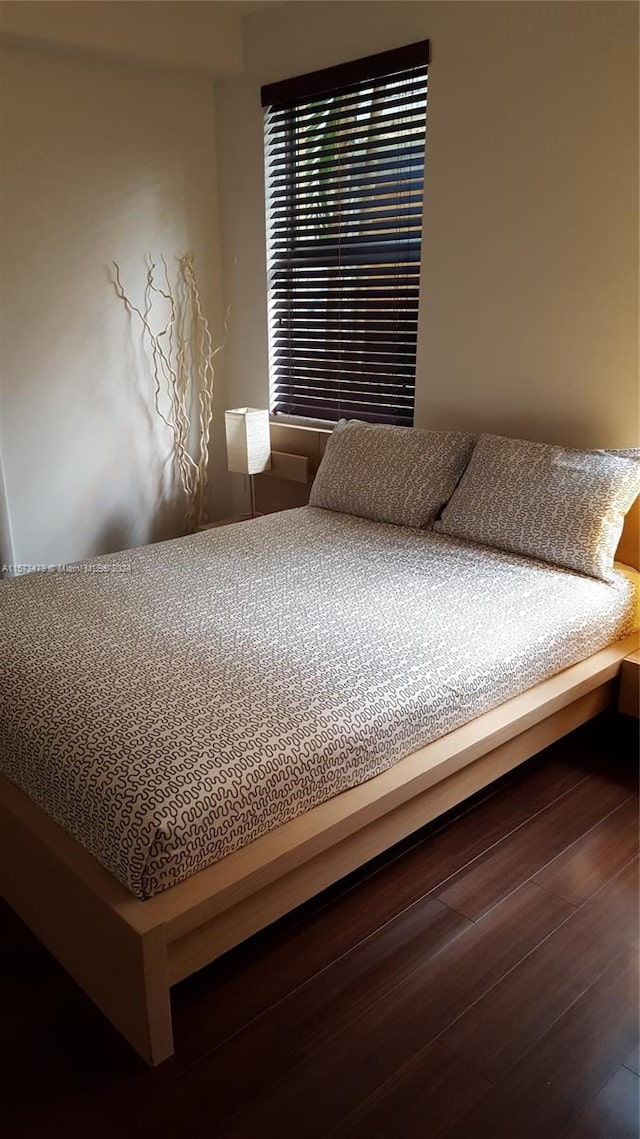 bedroom featuring dark hardwood / wood-style floors