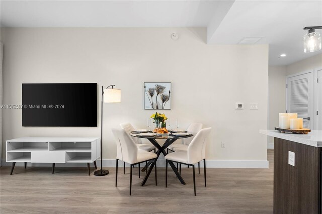 dining area with light hardwood / wood-style floors