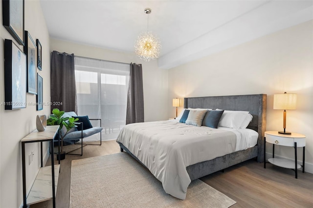 bedroom featuring light hardwood / wood-style flooring and an inviting chandelier