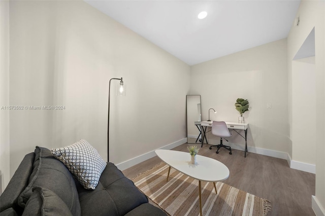 office featuring lofted ceiling and light hardwood / wood-style floors