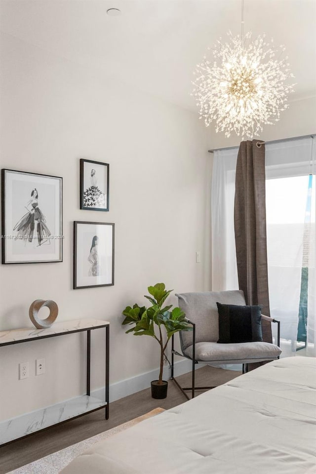 bedroom featuring a chandelier and light wood-type flooring