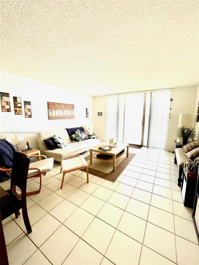 living room featuring a textured ceiling and light tile flooring