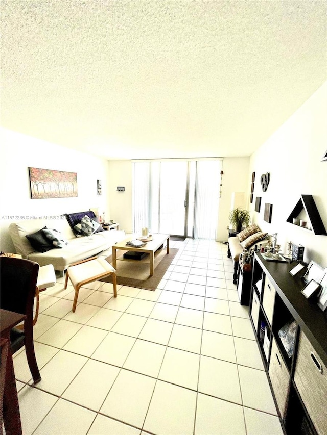 tiled living room featuring a textured ceiling