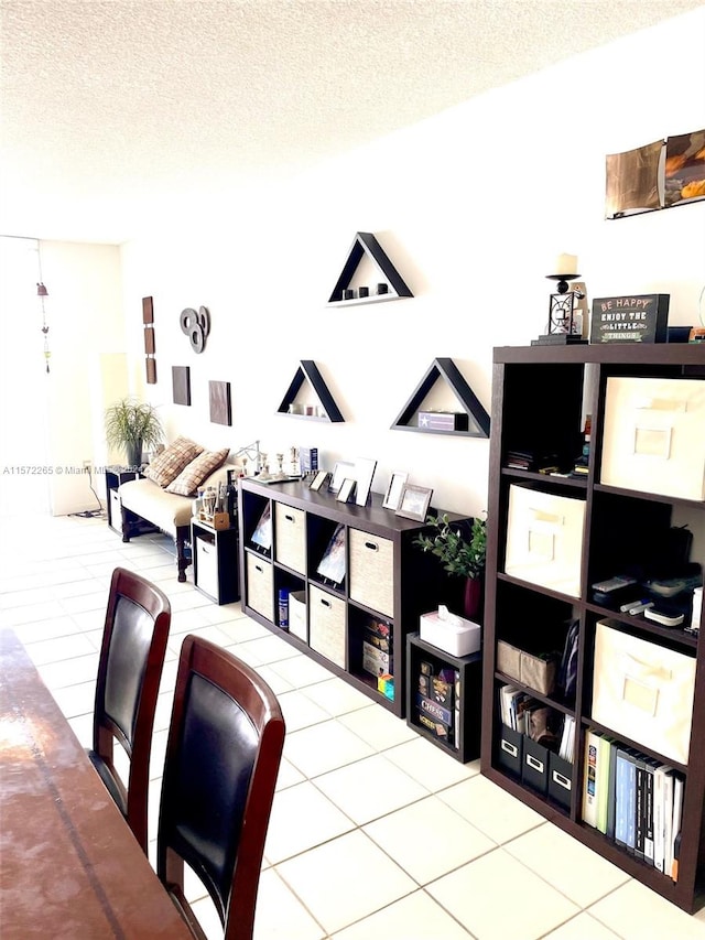 office area with a textured ceiling and tile floors