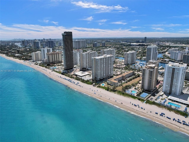 drone / aerial view with a water view and a beach view