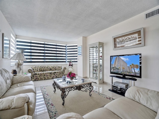 tiled living room with plenty of natural light and a textured ceiling