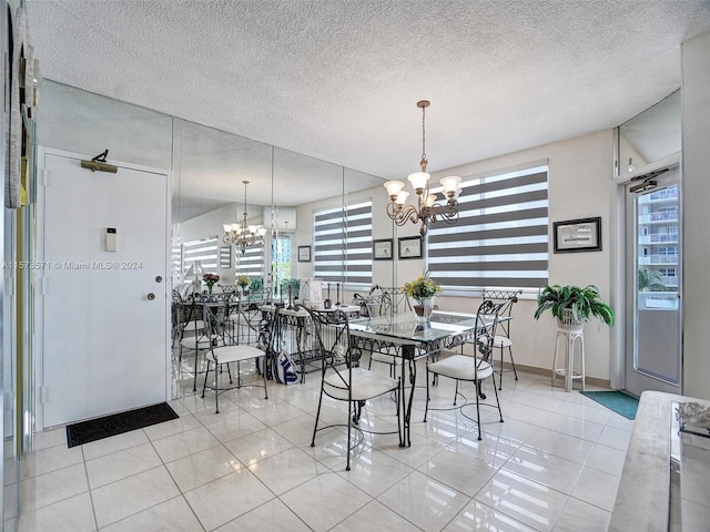 dining space featuring a chandelier, light tile floors, and a textured ceiling