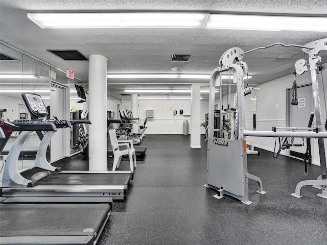 exercise room with a textured ceiling