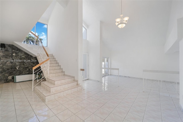 hallway featuring a notable chandelier, lofted ceiling with beams, and light tile floors