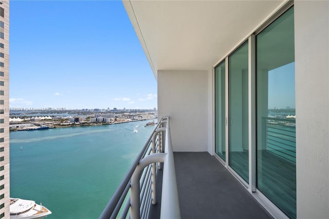 balcony featuring a city view and a water view