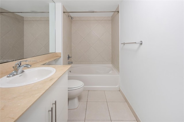 bathroom with bathtub / shower combination, toilet, vanity, tile patterned flooring, and baseboards