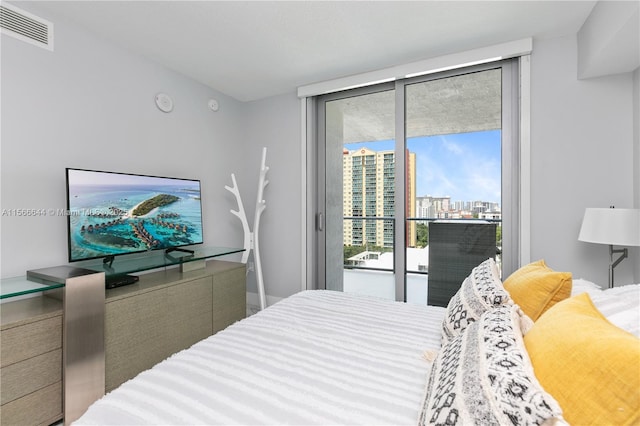 bedroom featuring access to exterior and floor to ceiling windows