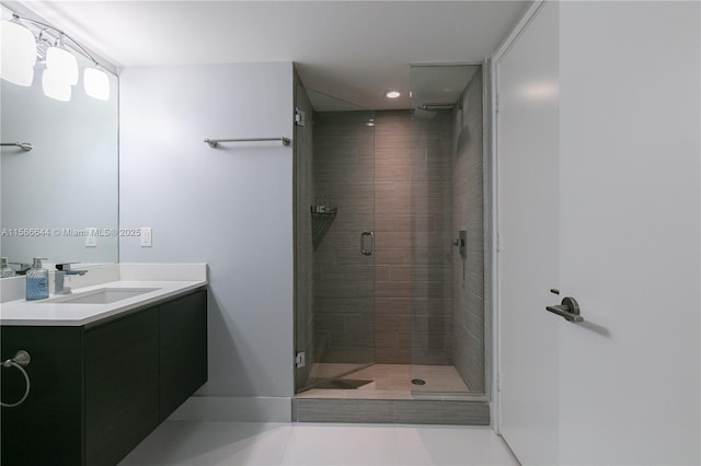 bathroom featuring vanity, tile patterned flooring, and walk in shower