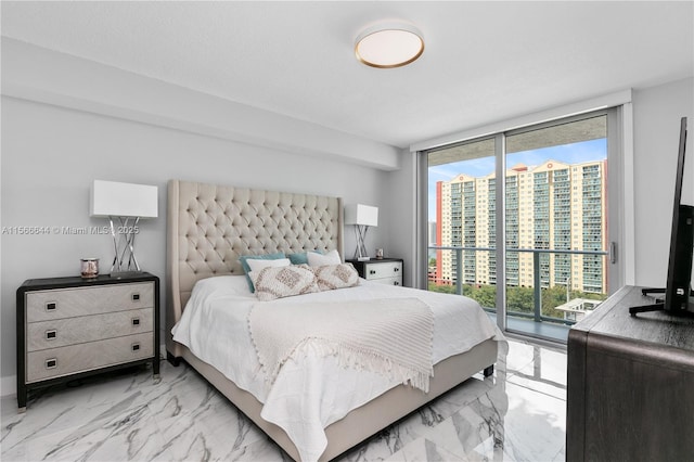 bedroom with a textured ceiling, access to exterior, and a wall of windows