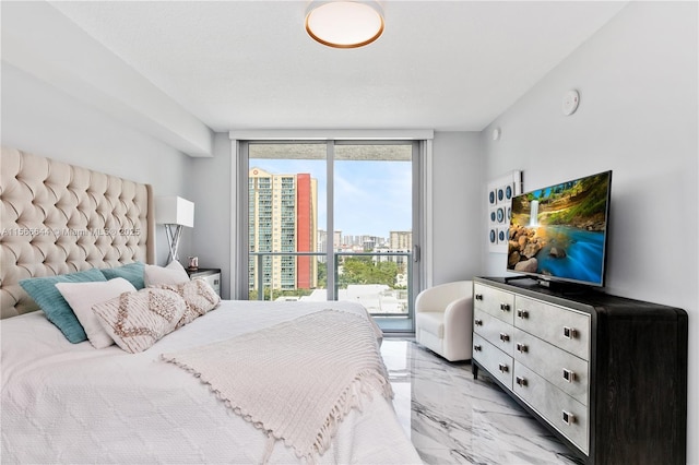 bedroom featuring access to exterior and a wall of windows