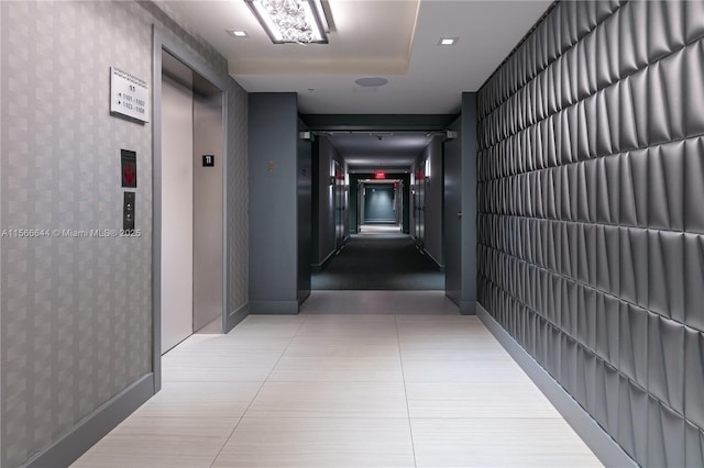 hallway with tile patterned floors