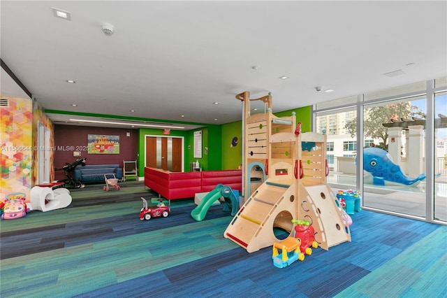 playroom with carpet and a wall of windows