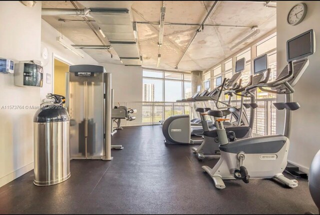 gym featuring floor to ceiling windows and a wealth of natural light