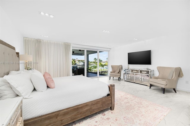 tiled bedroom featuring a wall of windows and access to exterior