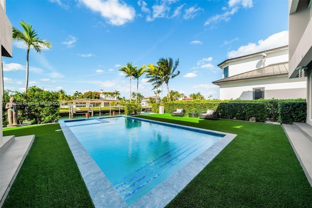 view of pool featuring a lawn