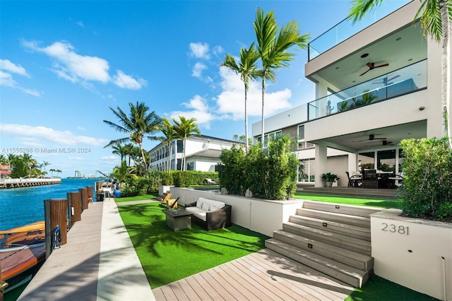 dock area featuring outdoor lounge area, a water view, and a balcony