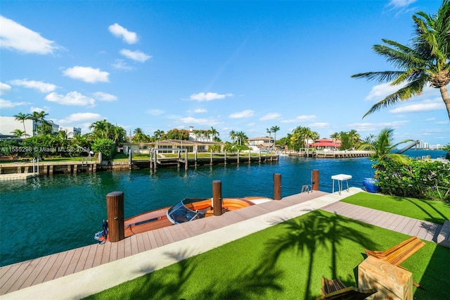 view of dock with a water view and a yard