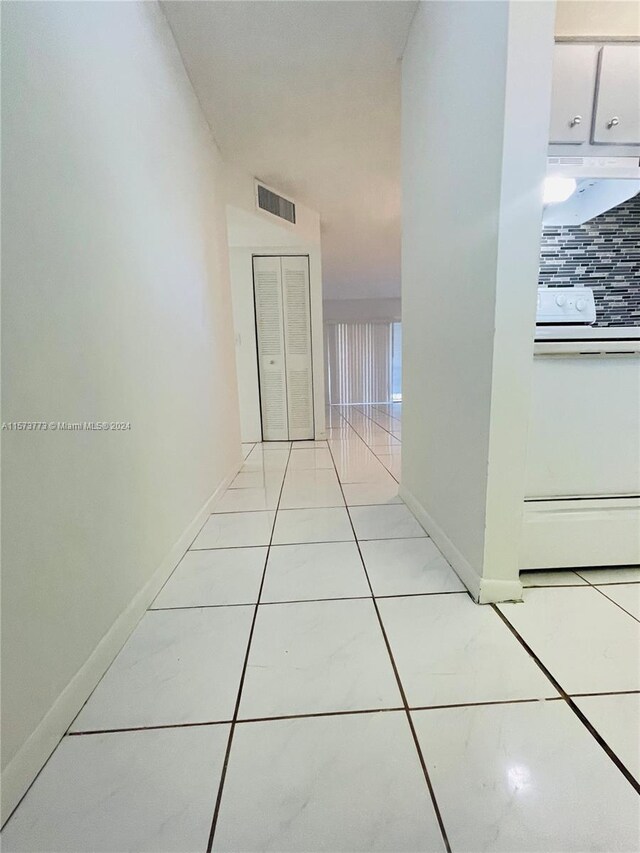 corridor featuring light tile flooring