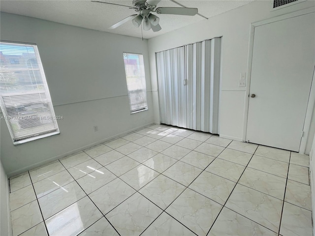 unfurnished bedroom featuring ceiling fan and light tile flooring