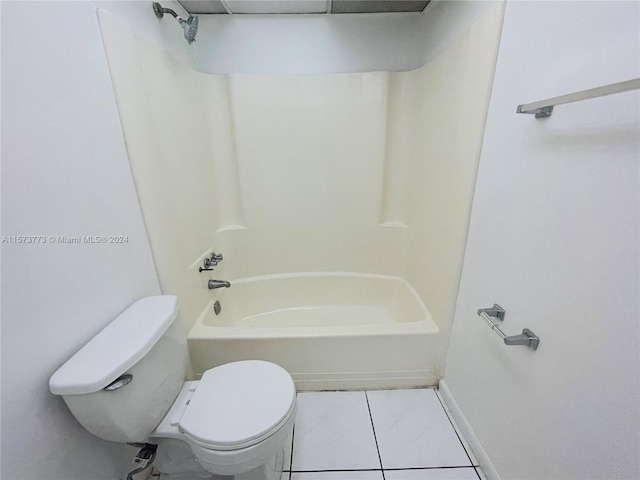 bathroom featuring shower / washtub combination, toilet, and tile floors