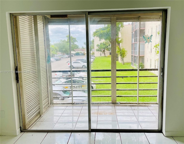 doorway to outside with tile floors