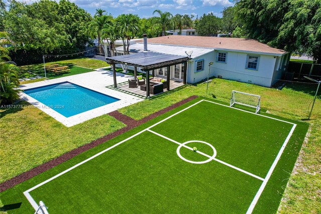 view of pool with a yard and a patio