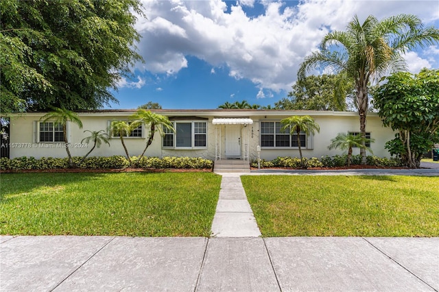 single story home featuring a front lawn