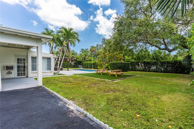 view of yard featuring a fenced in pool and a patio