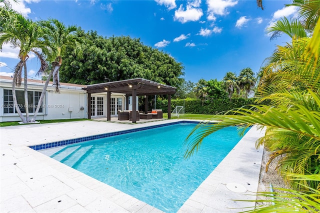 view of pool with a patio area, french doors, and a pergola