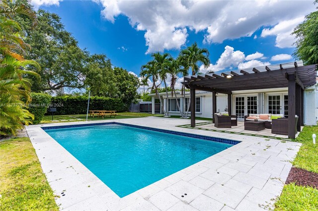 view of swimming pool featuring a patio area, a lawn, outdoor lounge area, and a pergola