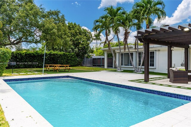 view of swimming pool featuring a patio, a pergola, and a yard