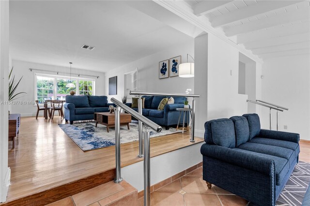 living room with tile floors and beamed ceiling