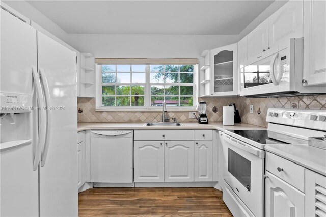 kitchen featuring white cabinetry, dark wood-type flooring, white appliances, and sink