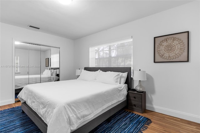 bedroom with a closet and hardwood / wood-style floors