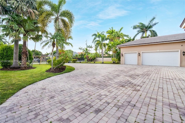 exterior space featuring a garage and a front yard