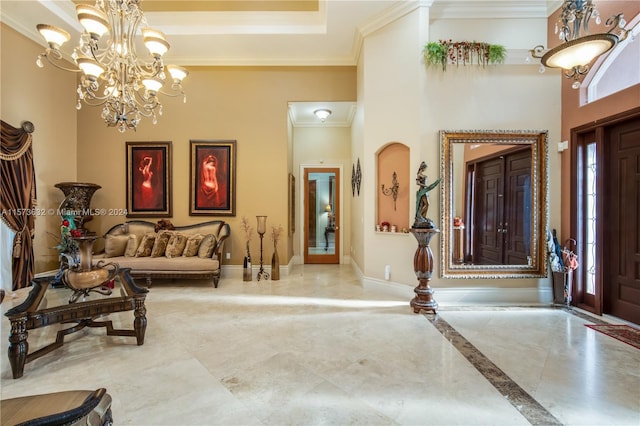 interior space featuring a chandelier, crown molding, a high ceiling, and a tray ceiling