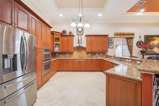 kitchen with sink, backsplash, a raised ceiling, a breakfast bar area, and stainless steel appliances