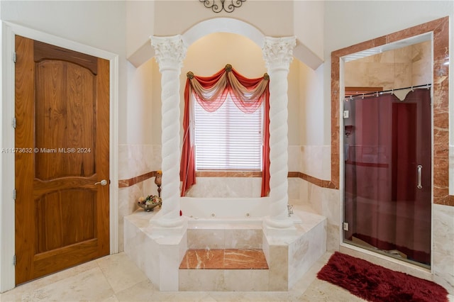 bathroom featuring decorative columns, separate shower and tub, and tile flooring