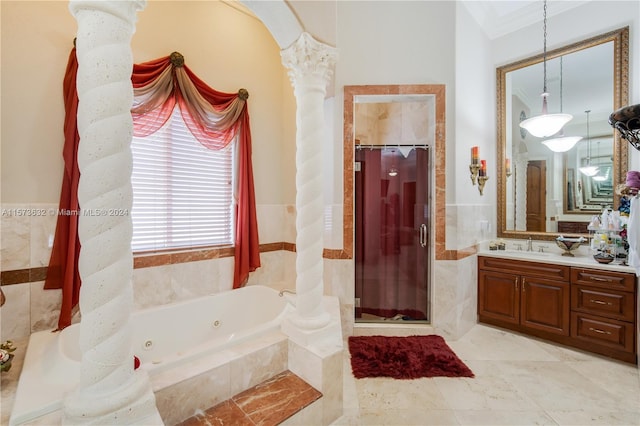 bathroom featuring oversized vanity, tile walls, ornate columns, and tile floors