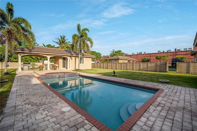 view of pool with a patio area and a yard