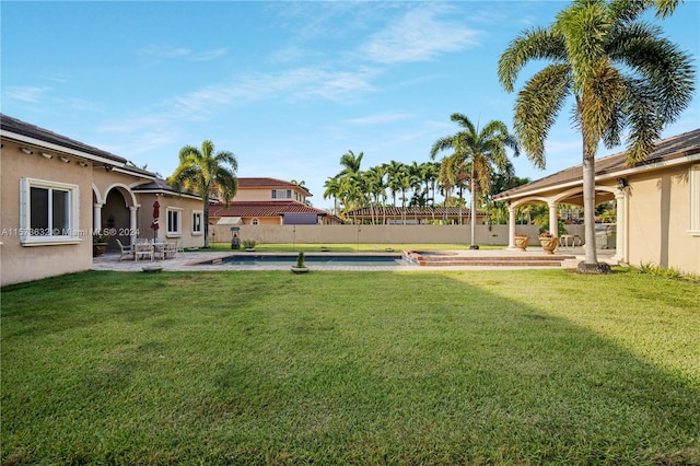 view of yard with a fenced in pool and a patio area