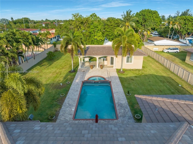 view of pool with a yard and a patio